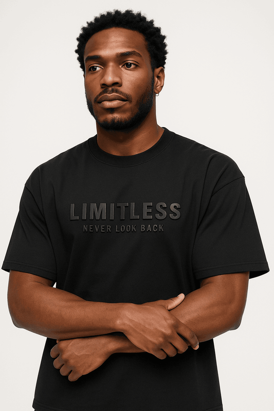 Trendy black oversized t-shirt with 3D 'LIMITLESS NEVER LOOK BACK' design, modeled for modern streetwear fashion. Sustainable organic cotton fabric.