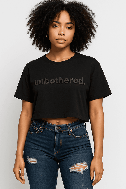 Unbothered Crop Top - Women’s Crop Tee in black with bold 'unbothered.' text, styled with ripped jeans for a casual, confident look.