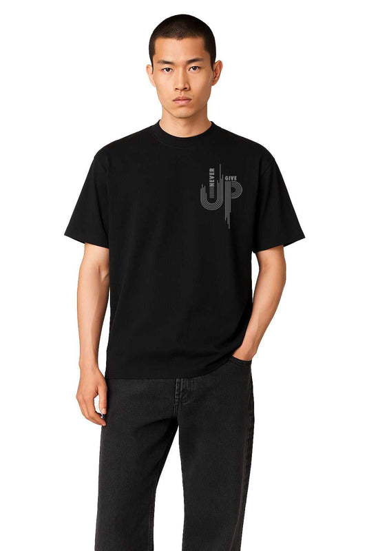Full front view of Never Give Up Men's streetwear t-shirt in oversized fit, styled with black jeans for a modern casual look.