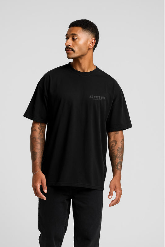No-Days-Off Oversize Streetwear t-shirt in black with subtle chest logo, styled with relaxed fit and dropped shoulders for casual streetwear appeal.