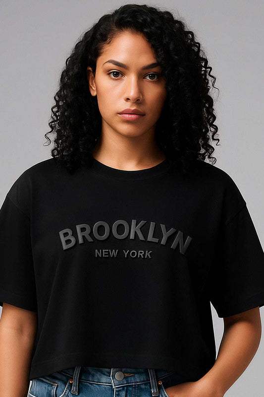 Close-up of Brooklyn Crop Top - Women's Crop Tee featuring soft cotton fabric and relaxed fit with embossed 'Brooklyn New York' lettering.