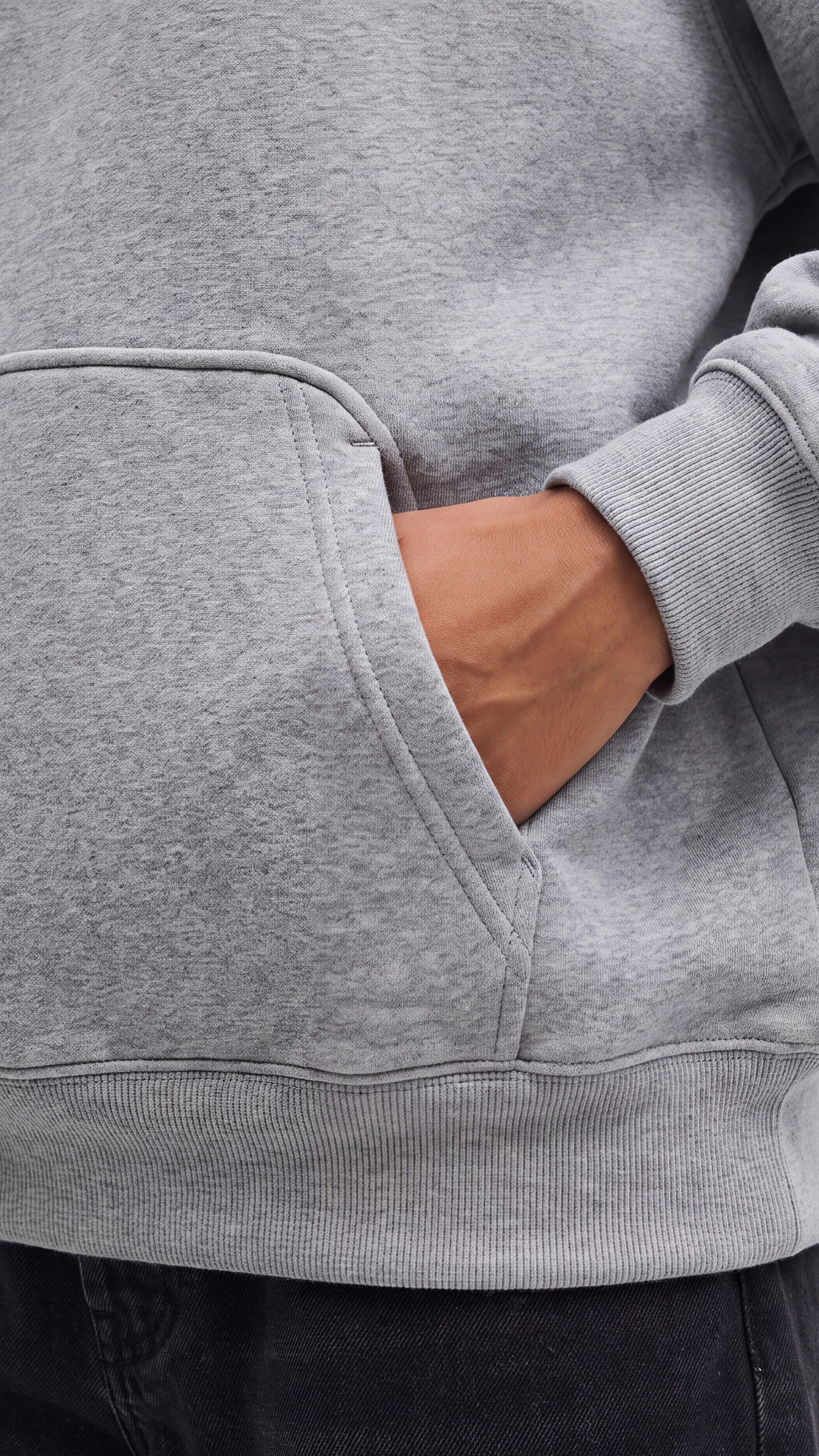 LIMITLESS Fleece Hoodie (Heather Grey) - detail of hand in kangaroo pocket with ribbed cuff and hem - Grind n Flow