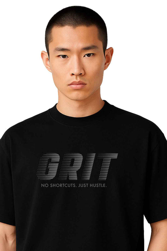 Close-up of GRIT - No Excuses black t-shirt showcasing minimalist 3D embossed text design, ideal for modern streetwear looks.