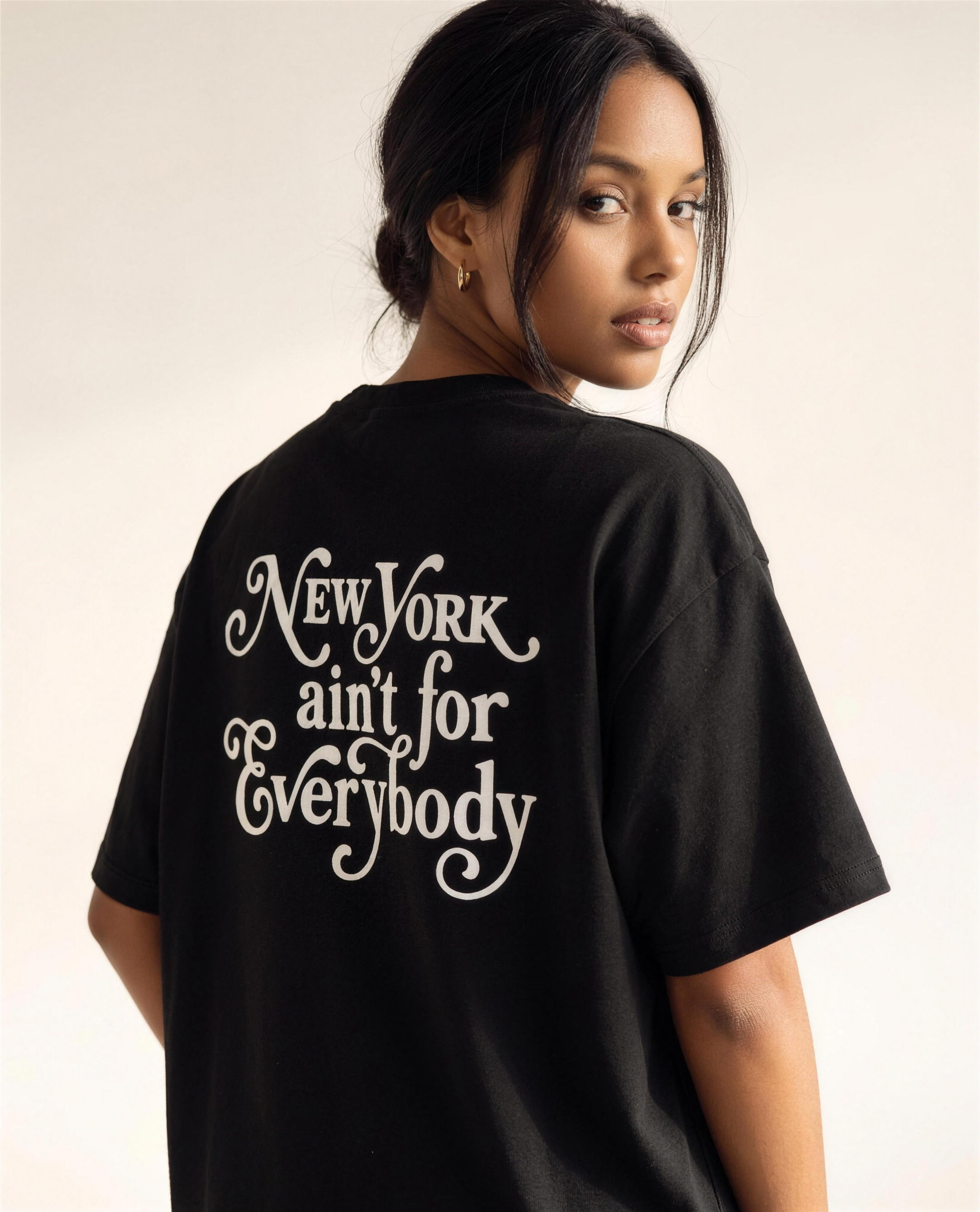 Model looking over her shoulder showing the back print