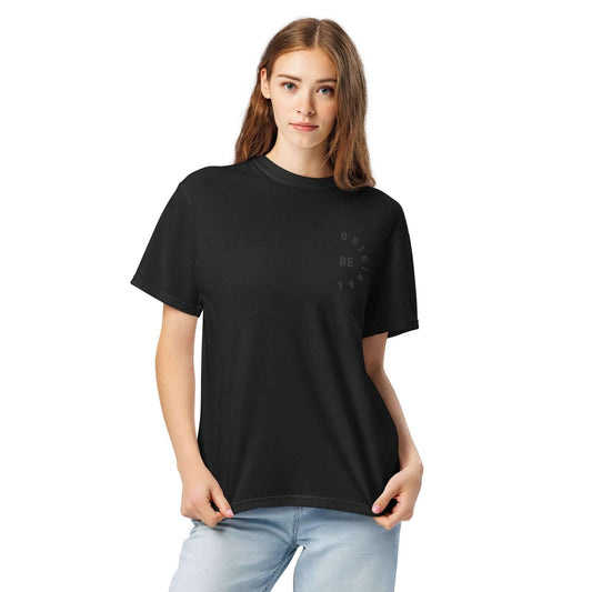 BE ORIGINAL minimalist women's t-shirt in black with subtle circular chest graphic, styled casually with light denim jeans.