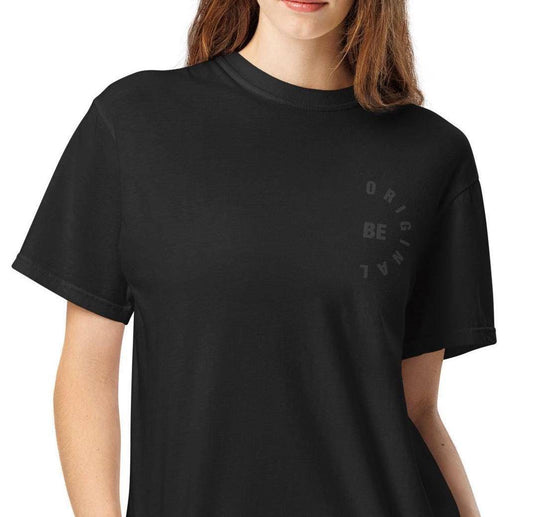 Close-up of BE ORIGINAL minimalist women's t-shirt showing the soft cotton fabric and subtle chest graphic design.